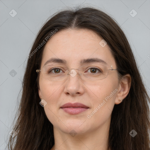 Joyful white adult female with long  brown hair and brown eyes