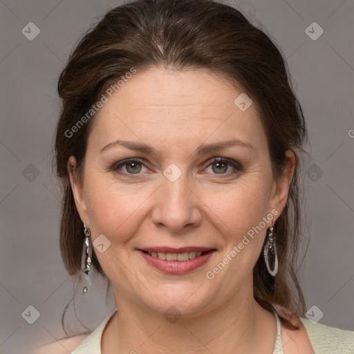 Joyful white adult female with medium  brown hair and grey eyes