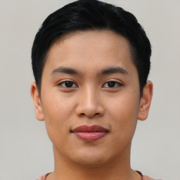 Joyful asian young-adult male with short  black hair and brown eyes