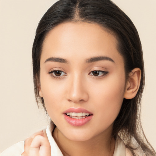 Joyful white young-adult female with long  brown hair and brown eyes