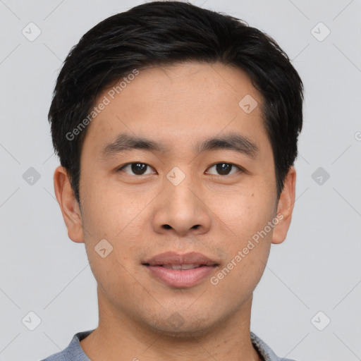 Joyful asian young-adult male with short  black hair and brown eyes