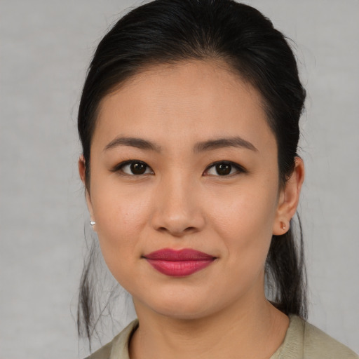 Joyful asian young-adult female with medium  brown hair and brown eyes