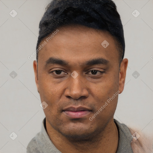 Neutral latino young-adult male with short  black hair and brown eyes