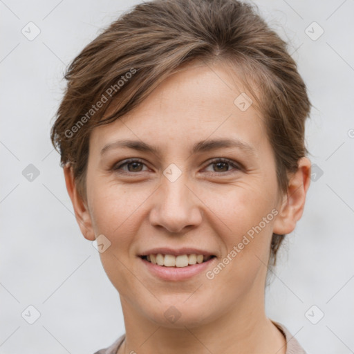 Joyful white young-adult female with short  brown hair and grey eyes