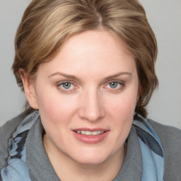 Joyful white young-adult female with medium  brown hair and blue eyes