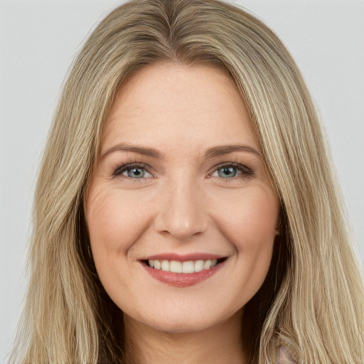 Joyful white young-adult female with long  brown hair and green eyes