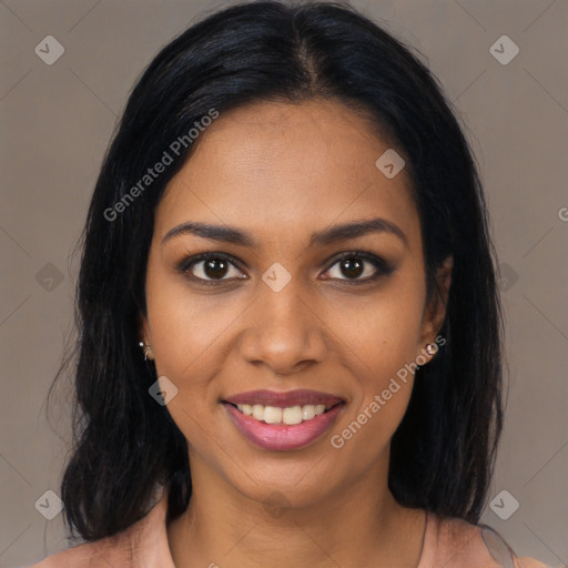 Joyful black young-adult female with long  brown hair and brown eyes