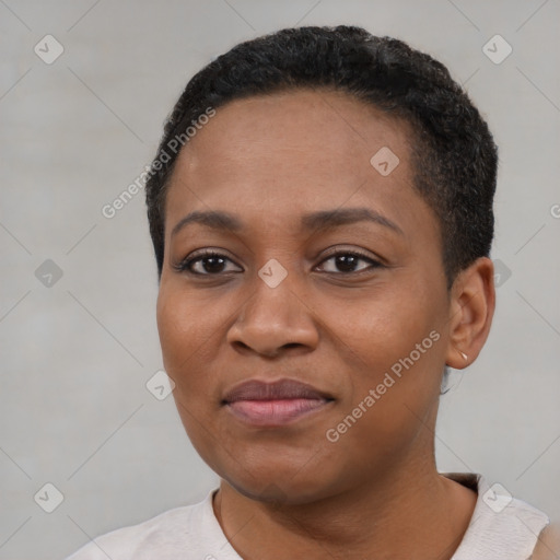 Joyful black young-adult female with short  black hair and brown eyes