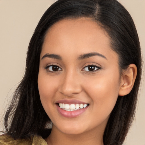 Joyful latino young-adult female with long  brown hair and brown eyes