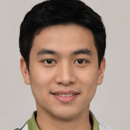 Joyful white young-adult male with short  black hair and brown eyes