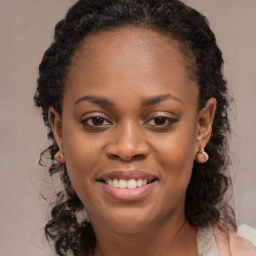 Joyful black young-adult female with medium  black hair and brown eyes