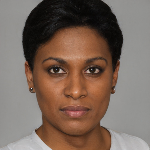 Joyful black young-adult female with short  brown hair and brown eyes