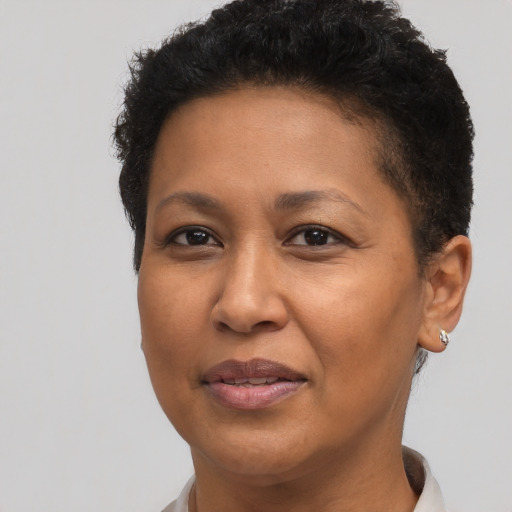 Joyful black adult female with short  brown hair and brown eyes