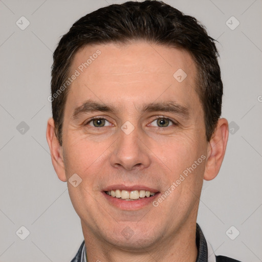 Joyful white adult male with short  brown hair and grey eyes