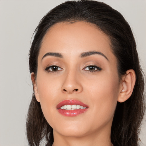 Joyful white young-adult female with long  brown hair and brown eyes