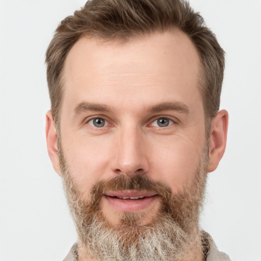 Joyful white adult male with short  brown hair and grey eyes