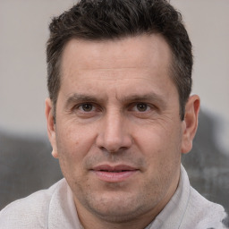 Joyful white adult male with short  brown hair and brown eyes