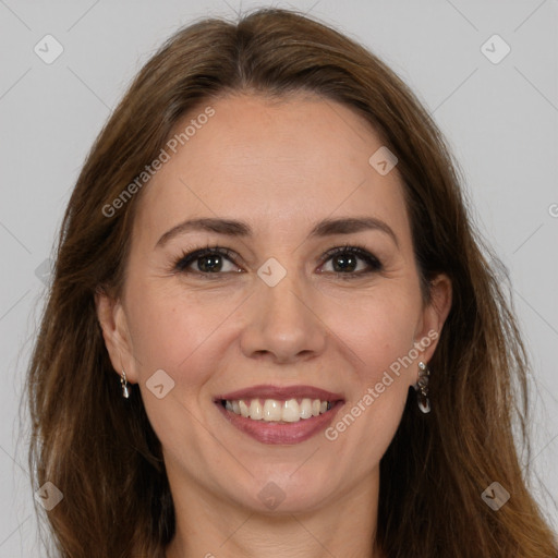 Joyful white adult female with long  brown hair and brown eyes