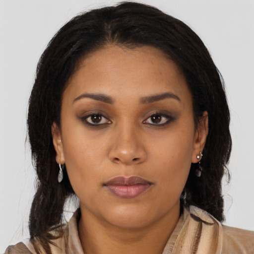 Joyful latino young-adult female with long  brown hair and brown eyes