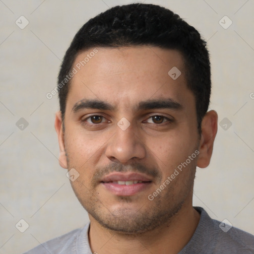 Joyful latino young-adult male with short  black hair and brown eyes