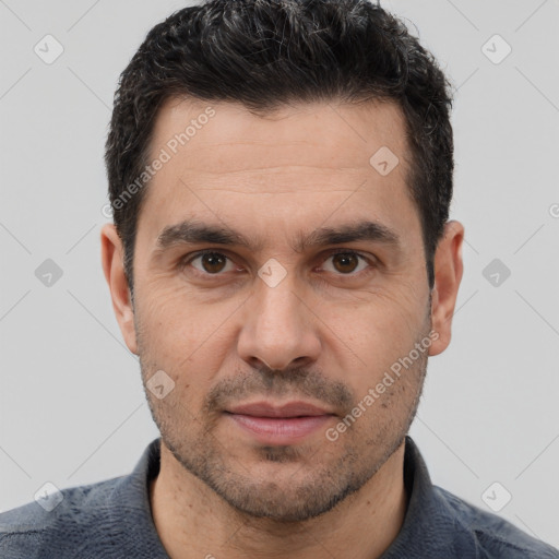 Joyful white adult male with short  black hair and brown eyes