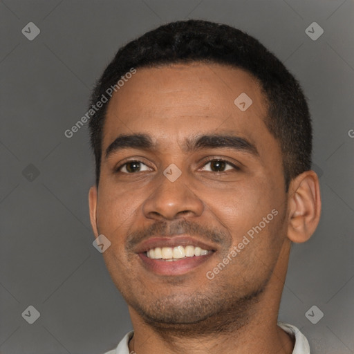 Joyful black young-adult male with short  black hair and brown eyes