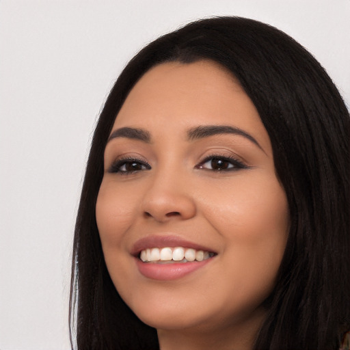 Joyful latino young-adult female with long  black hair and brown eyes