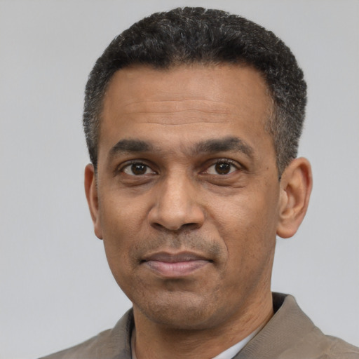 Neutral latino adult male with short  black hair and brown eyes