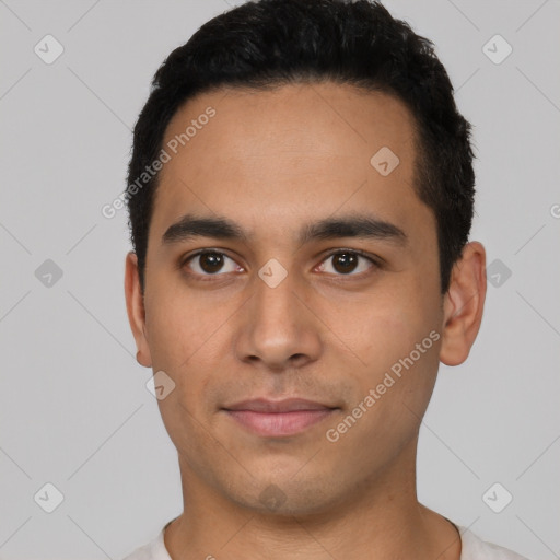 Joyful latino young-adult male with short  black hair and brown eyes