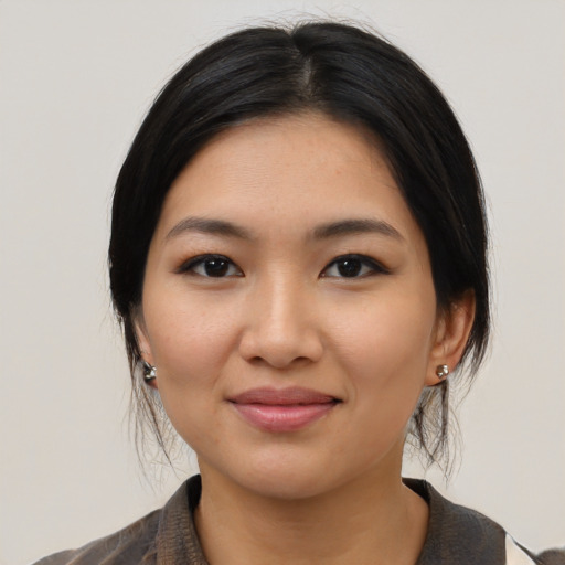 Joyful latino young-adult female with medium  black hair and brown eyes