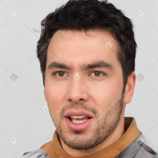 Joyful white young-adult male with short  black hair and brown eyes