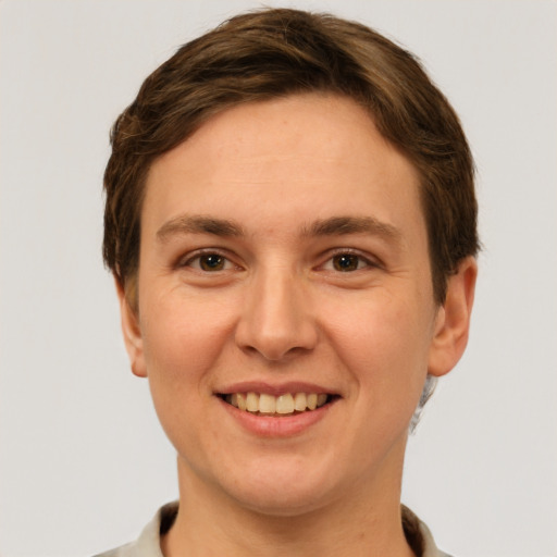 Joyful white young-adult female with short  brown hair and grey eyes