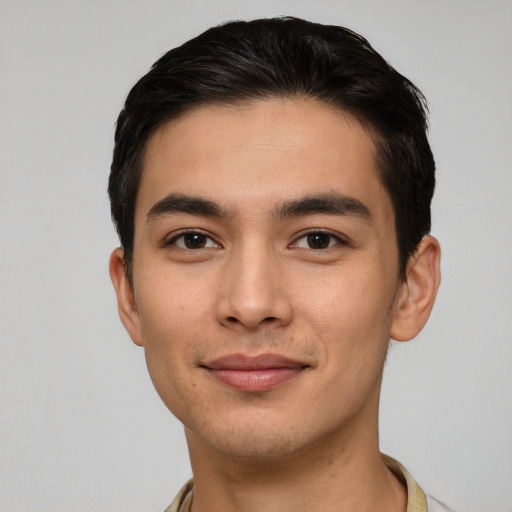 Joyful white young-adult male with short  black hair and brown eyes