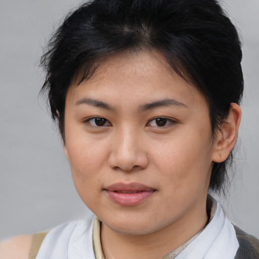 Joyful asian young-adult female with medium  brown hair and brown eyes