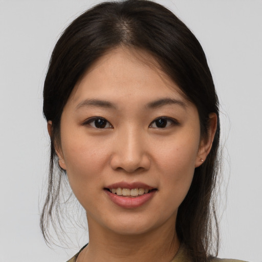 Joyful asian young-adult female with medium  brown hair and brown eyes