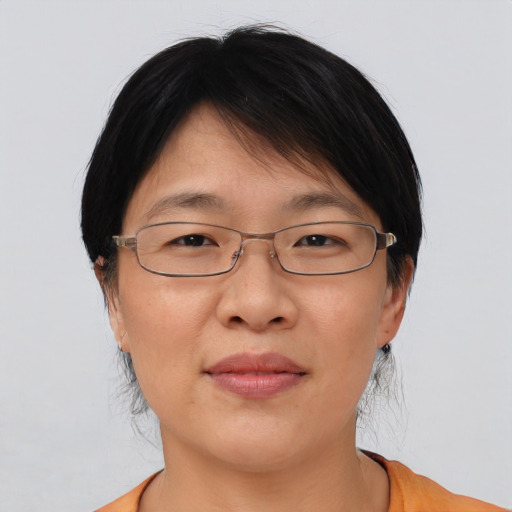 Joyful asian adult female with medium  brown hair and brown eyes