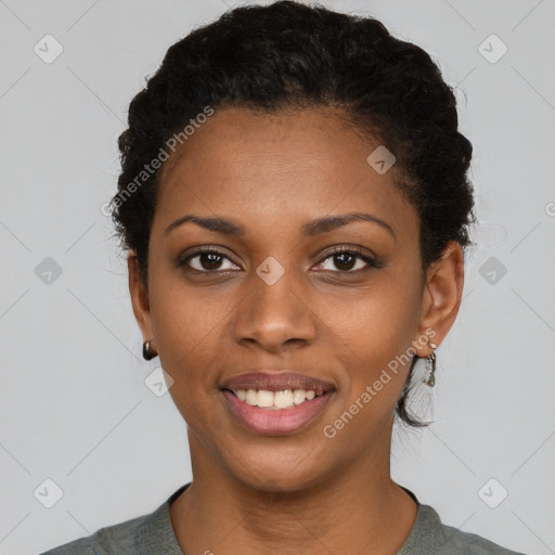 Joyful black young-adult female with short  black hair and brown eyes