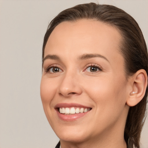 Joyful white young-adult female with long  brown hair and brown eyes