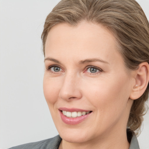 Joyful white young-adult female with medium  brown hair and blue eyes