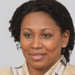 Joyful black adult female with medium  brown hair and brown eyes