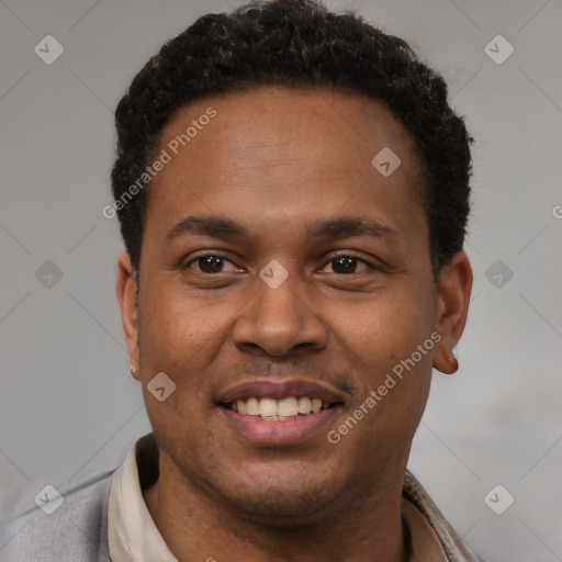 Joyful latino young-adult male with short  black hair and brown eyes