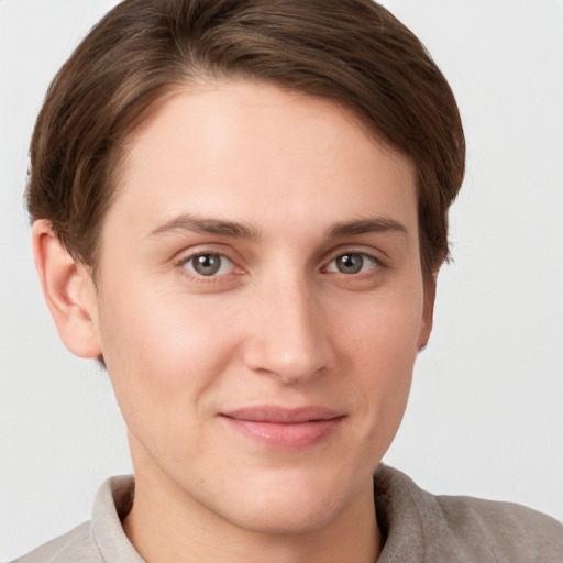 Joyful white young-adult female with short  brown hair and grey eyes