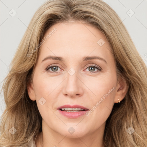 Joyful white adult female with long  brown hair and brown eyes