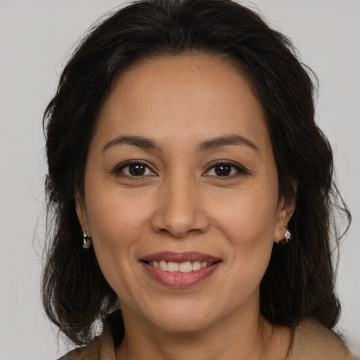 Joyful white adult female with medium  brown hair and brown eyes