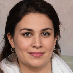 Joyful white adult female with medium  brown hair and brown eyes