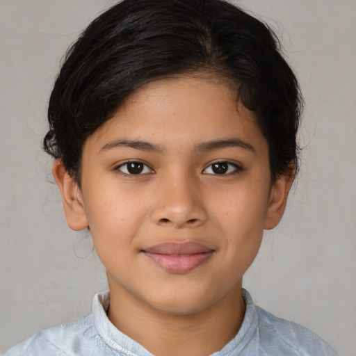 Joyful latino child female with medium  brown hair and brown eyes