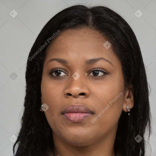 Joyful black young-adult female with long  brown hair and brown eyes