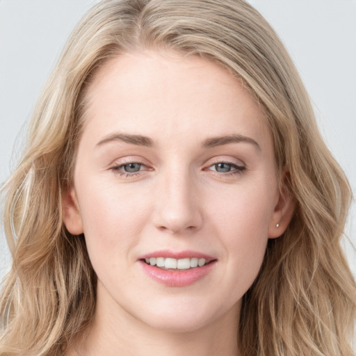 Joyful white young-adult female with long  brown hair and blue eyes