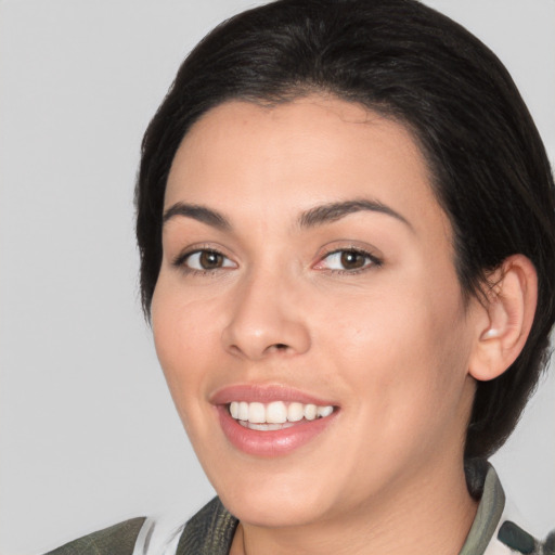 Joyful white young-adult female with medium  black hair and brown eyes