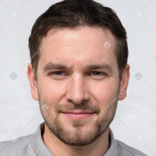 Joyful white adult male with short  brown hair and brown eyes